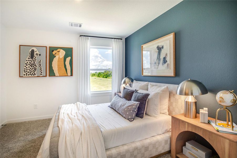 This cozy bedroom features and ample natural light from a large window with serene outside views. This cozy bedroom features and ample natural light from a large window with serene outside views.