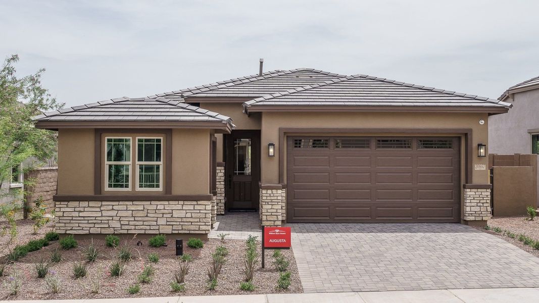 Front exterior of a new home in Fairways in Victory at Verrado, Buckeye, AZ, highlighting curb appeal (Image 1).