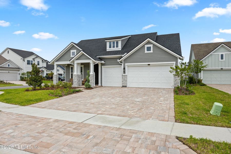 Front exterior of a new home in Oak Grove at SilverLeaf 60’, St. Augustine, FL, highlighting curb appeal (Image 21).