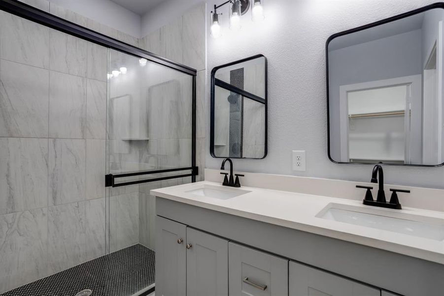 Bathroom with double vanity and a stall shower Bathroom with double vanity and a stall shower