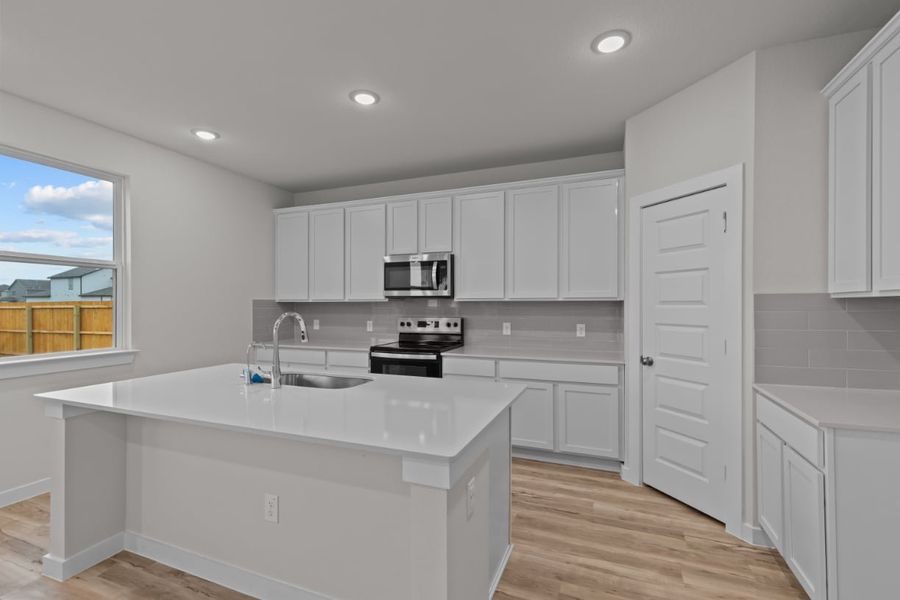 A kitchen with white cabinets. A kitchen with white cabinets.