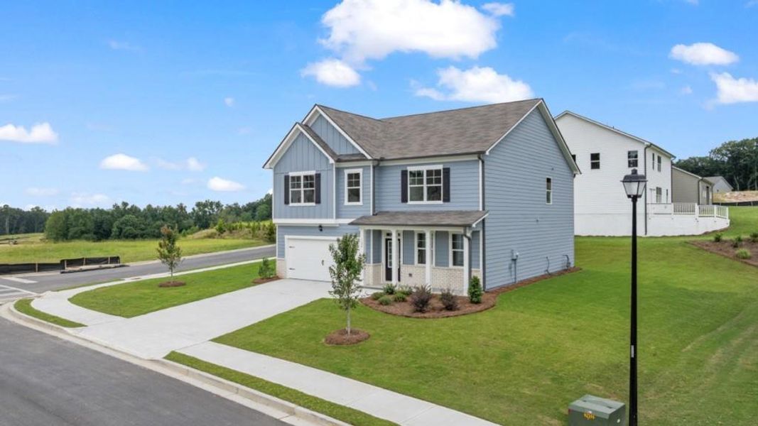 Front exterior of a new home in Liberty Crossing, Braselton, GA, highlighting curb appeal (Image 2).
