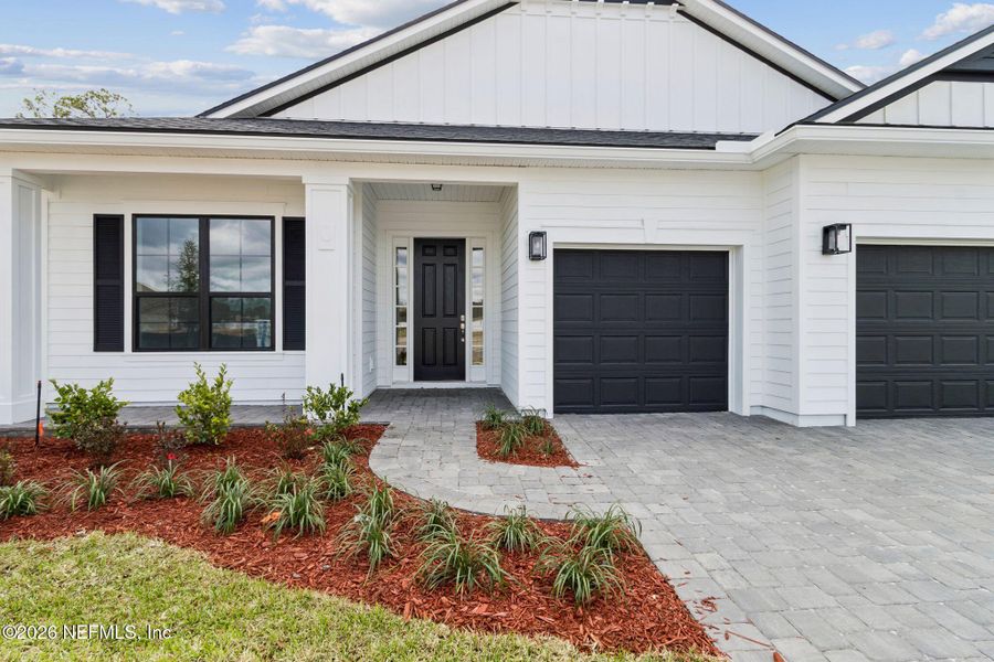 Front exterior of a new home in Sandy Ridge, Yulee, FL, highlighting curb appeal (Image 2).