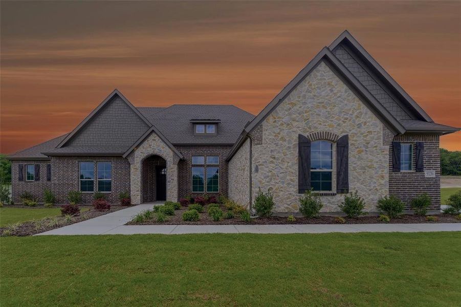 Craftsman-style exterior featuring a combination of brick and stone masonry, dark shingle roofing, decorative gables, and wood shutters