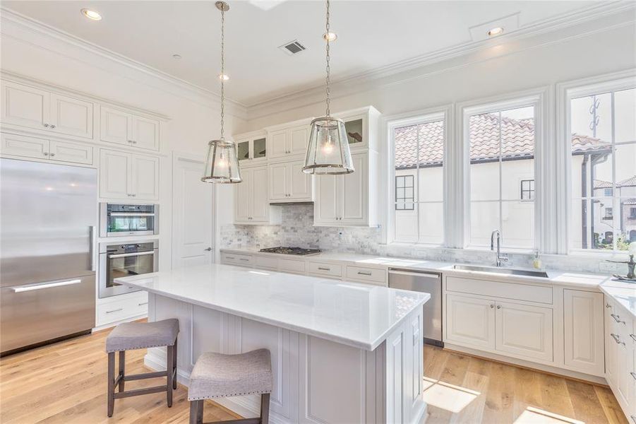 12' ceilings, extended cabinets, and lots of natural light create an airy and open kitchen with plenty of storage, similar to this previous build