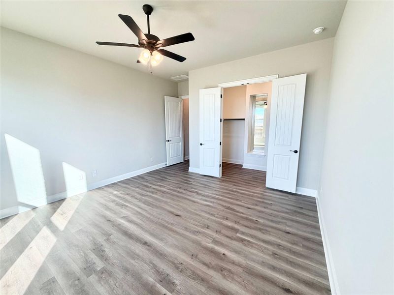 Unfurnished bedroom with light wood-style flooring and ceiling fan Unfurnished bedroom with light wood-style flooring and ceiling fan