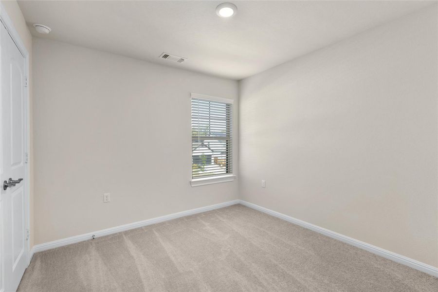 Spare room with light colored carpet and baseboards