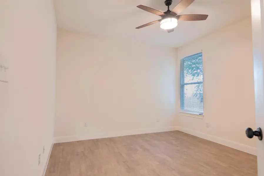 Spare room with light wood finished floors and ceiling fan Spare room with light wood finished floors and ceiling fan