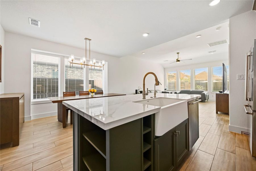 The kitchen opens beautifully to the dining and living rooms, creating a warm, connected setting where cooking, conversation and entertaining flow seamlessly from one space to the next. The kitchen opens beautifully to the dining and living rooms, creating a warm, connected setting where cooking, conversation and entertaining flow seamlessly from one space to the next.