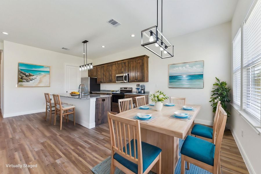 Virtually Staged Dining room with visible vents, plenty of natural light, baseboards, and wood finished floors Virtually Staged Dining room with visible vents, plenty of natural light, baseboards, and wood finished floors