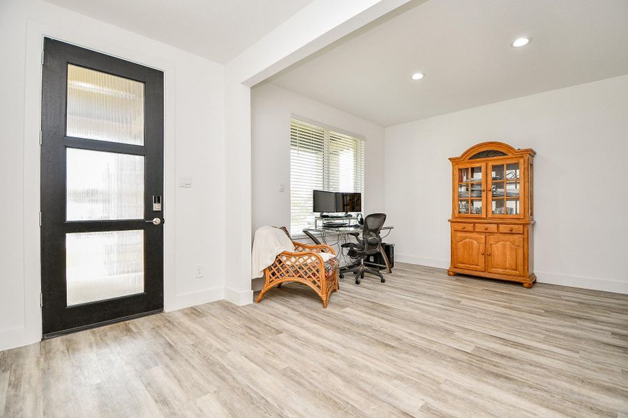 Bright, open entry room with modern vinyl plank flooring. Features a large window for natural light, and space for an office setup or formal dining room. Bright, open entry room with modern vinyl plank flooring. Features a large window for natural light, and space for an office setup or formal dining room.