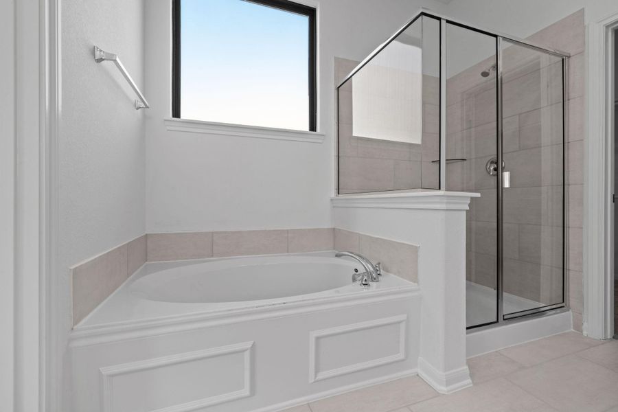 This additional view of your primary bathroom features tile flooring, fresh paint, walk-in shower, a separate garden tub, and a large walk-in closet. This additional view of your primary bathroom features tile flooring, fresh paint, walk-in shower, a separate garden tub, and a large walk-in closet.