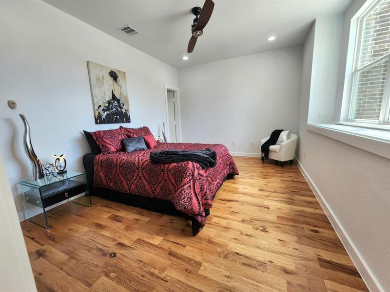 Bedroom with hardwood / wood-style flooring and ceiling fan