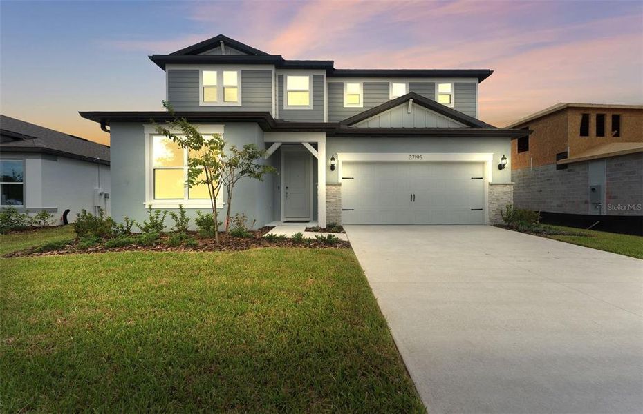Front exterior of a new home in Riverwood, Zephyrhills, FL, highlighting curb appeal (Image 1).