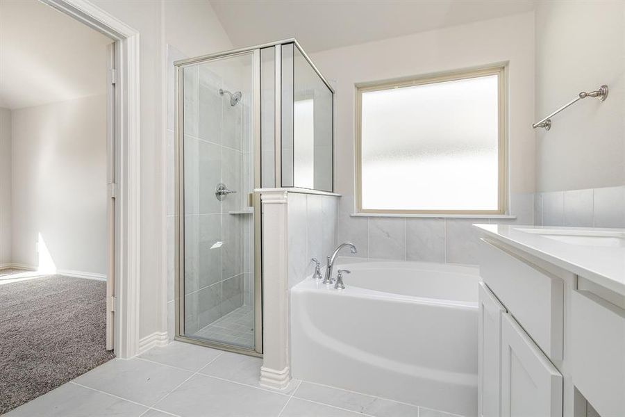 Bathroom with separate shower and tub, tile patterned flooring, vanity, and vaulted ceiling