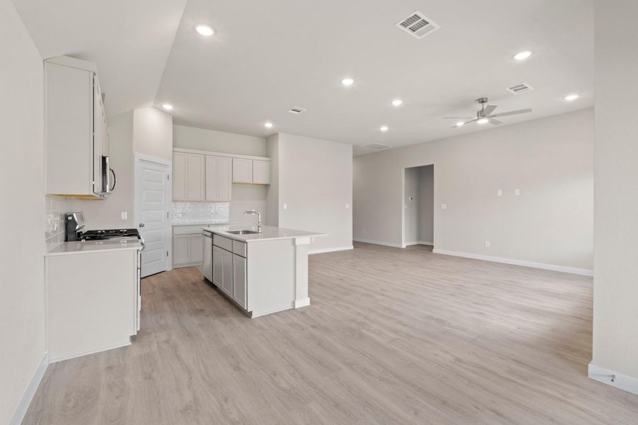 An open concept design seamlessly blends a functional kitchen with an inviting living space.