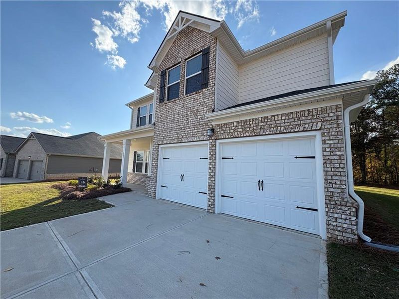 Front exterior of a new home in Southern Hills, McDonough, GA, highlighting curb appeal (Image 2).