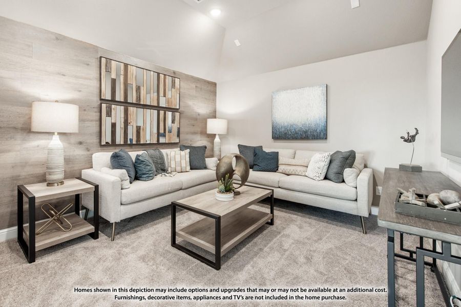 Living room with two beige sofas, wood accent wall, vaulted ceiling, and neutral carpet flooring Living room with two beige sofas, wood accent wall, vaulted ceiling, and neutral carpet flooring