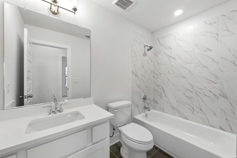 Bathroom featuring vanity, shower combination, and recessed lighting Bathroom featuring vanity, shower combination, and recessed lighting