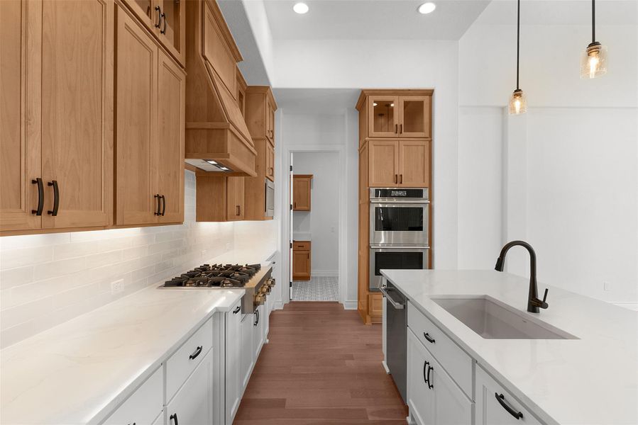 Culinary aspirations come alive in this well-appointed kitchen, featuring a spacious island and professional-grade appliances.