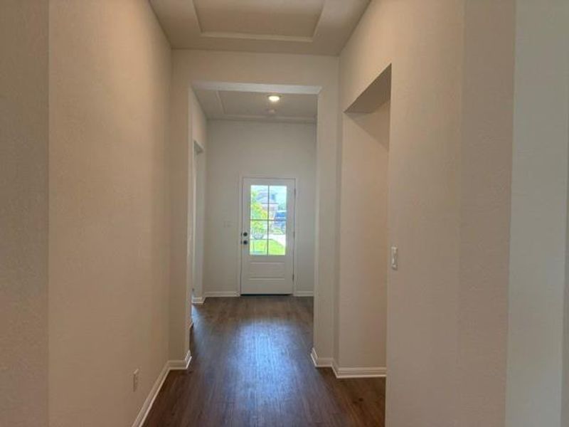 Entryway featuring wood-finish flooring, recessed lighting, and a front door with decorative glass panes
