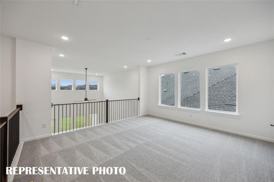 The light and bright family room with adjacent media room create the ultimate family entertainment zone!  REPRESENTATIVE PHOTO