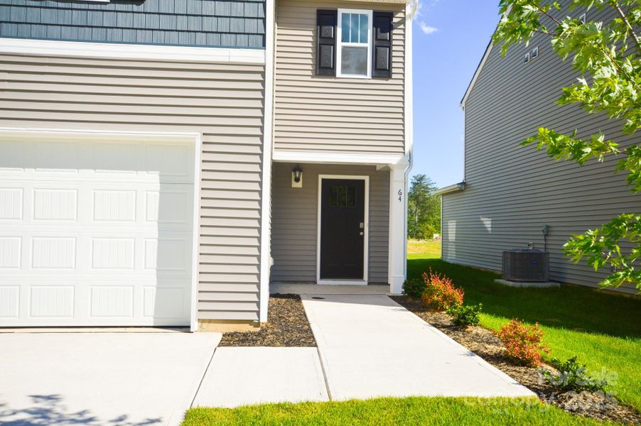Front exterior of a new home in Providence Walk, Hendersonville, NC, highlighting curb appeal (Image 1).