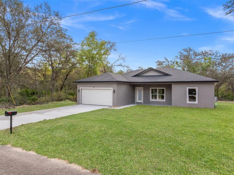 Front exterior of a new home in , Ocklawaha, FL, highlighting curb appeal (Image 18).