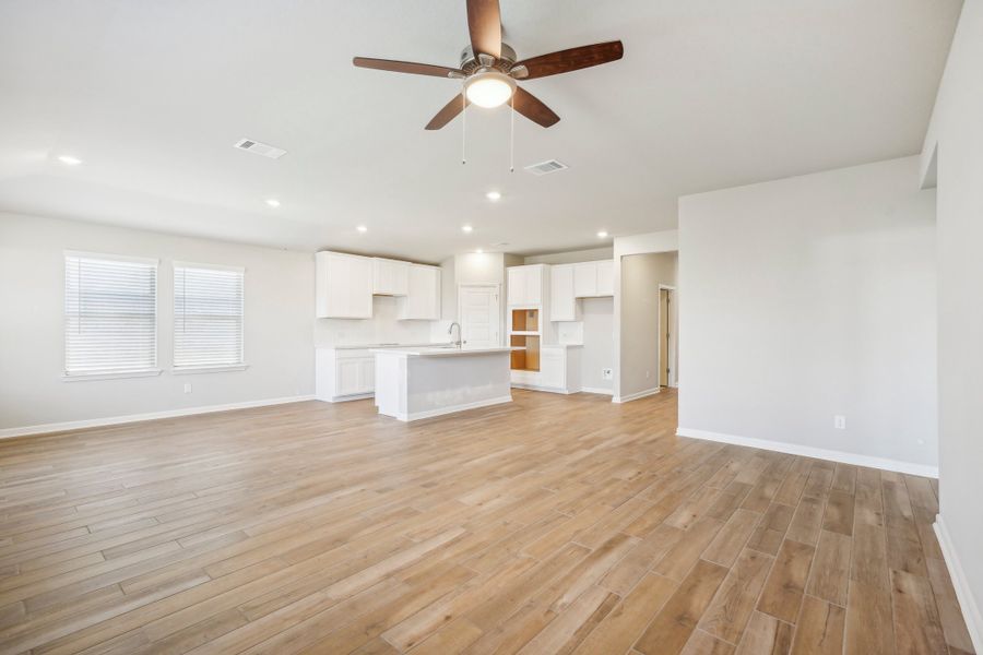 Dining room and living room in the Fitzhugh floorplan at a Meritage homes community.