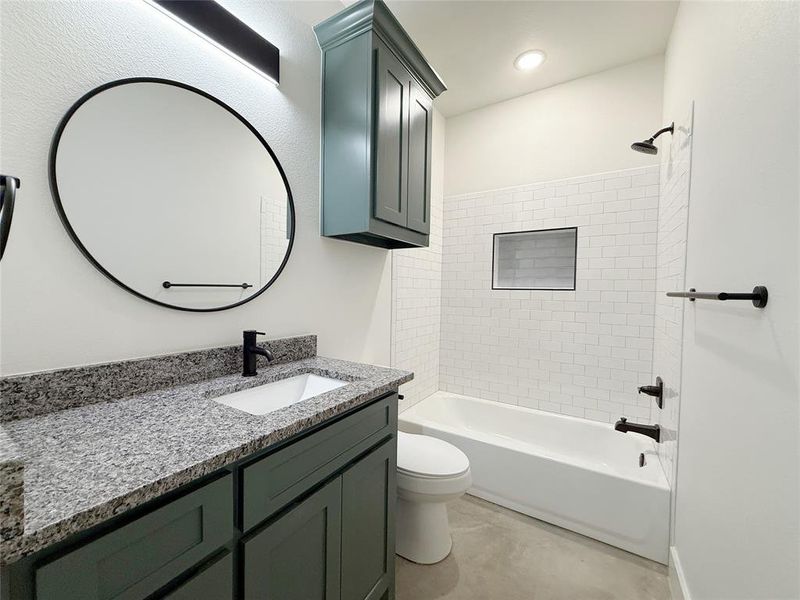 Full bathroom featuring vanity, bathtub / shower combination, and toilet Full bathroom featuring vanity, bathtub / shower combination, and toilet