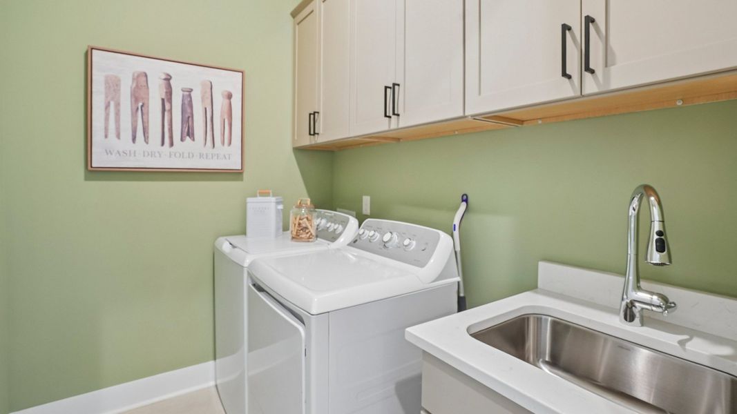 Dedicated laundry room with cabinets and sink Dedicated laundry room with cabinets and sink