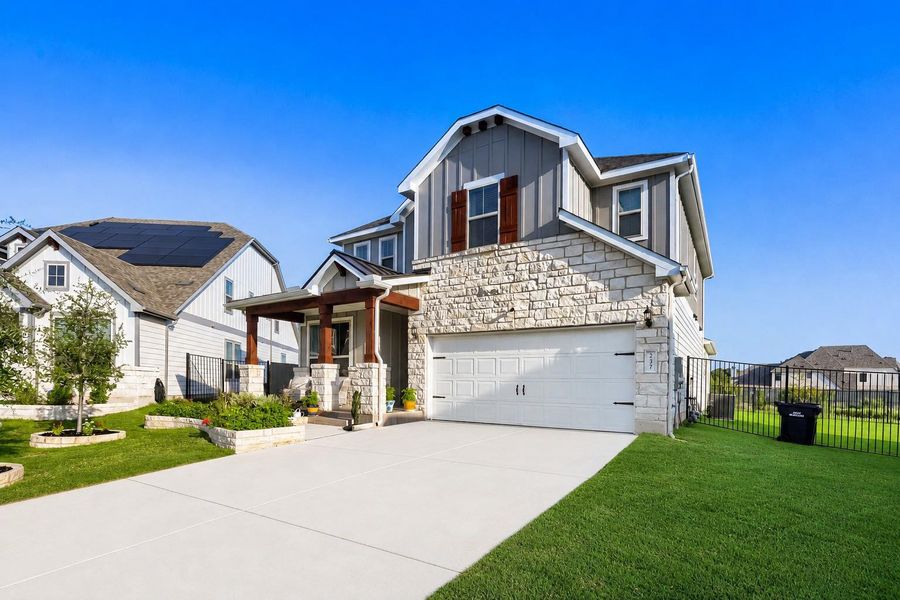 A well-maintained facade features an inviting covered porch and an attached garage. A well-maintained facade features an inviting covered porch and an attached garage.