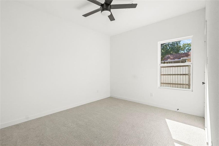 Empty room featuring carpet and ceiling fan