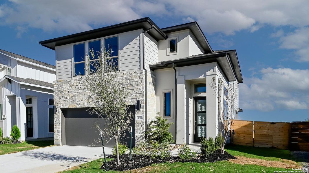 Front exterior of a new home in Solms Landing 45', New Braunfels, TX, highlighting curb appeal (Image 21).