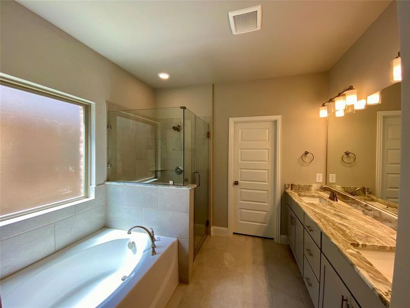 Dual vanities with Fantasy Brown granite in master bathroom. Dual vanities with Fantasy Brown granite in master bathroom.