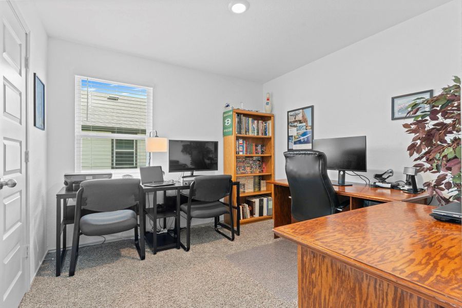 Versatile secondary bedroom currently used as a home office — featuring plush carpet, large window for natural light, and plenty of room for desks, bookshelves, or seating. Versatile secondary bedroom currently used as a home office — featuring plush carpet, large window for natural light, and plenty of room for desks, bookshelves, or seating.