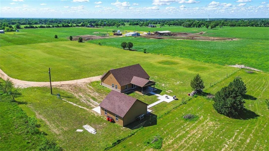 View of rural area with agricultural land and a tree filled landscape View of rural area with agricultural land and a tree filled landscape