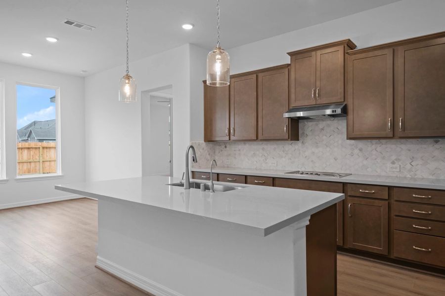 Kitchen and breakfast. Note: Sample product photo - actual exterior and interior selections may vary by homesite