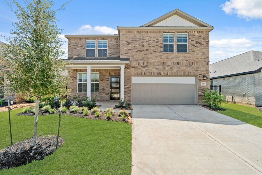 Front exterior of a new home in Sunterra, Katy, TX, highlighting curb appeal (Image 15). Front exterior of a new home in Sunterra, Katy, TX, highlighting curb appeal (Image 15).