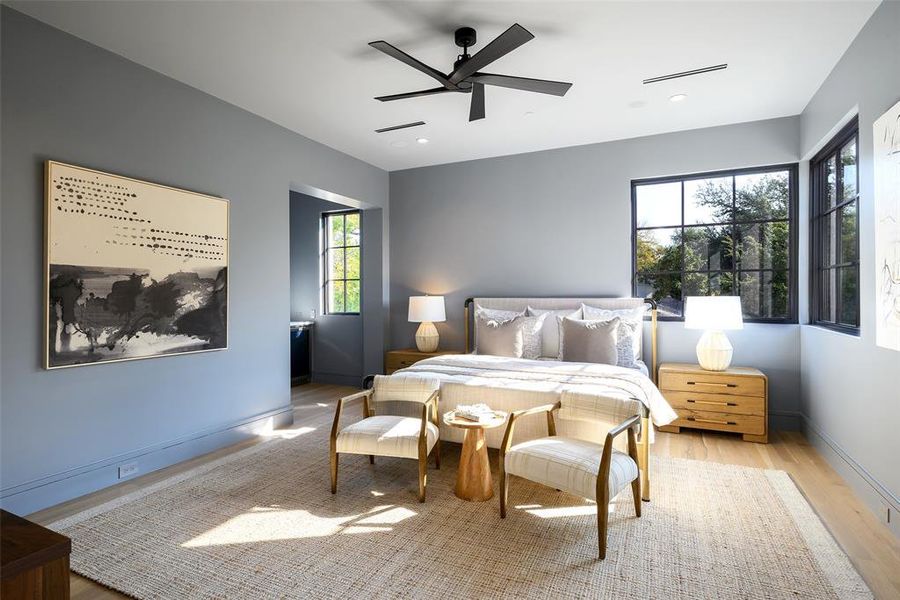 Bedroom with light wood-type flooring, a ceiling fan, and recessed lighting Bedroom with light wood-type flooring, a ceiling fan, and recessed lighting