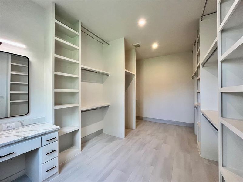 Walk in closet featuring light hardwood / wood-style floors