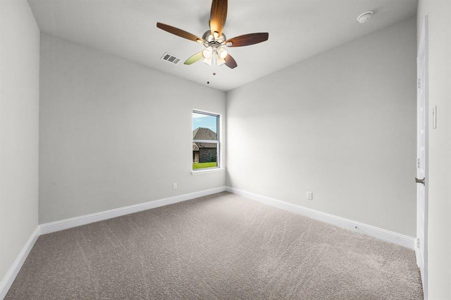 Unfurnished room featuring carpet and a ceiling fan Unfurnished room featuring carpet and a ceiling fan