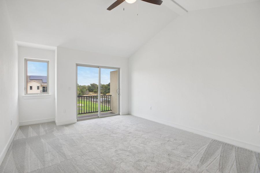 Empty room with light colored carpet and a ceiling fan