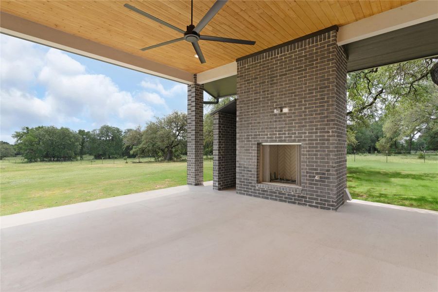 View of patio featuring ceiling fan and view of scattered trees View of patio featuring ceiling fan and view of scattered trees