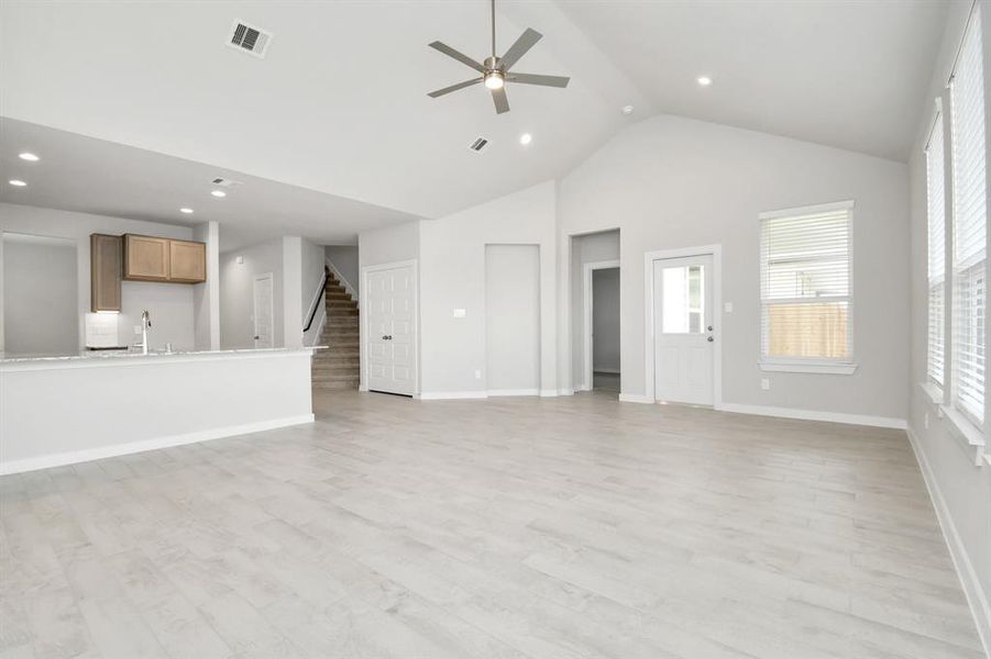 Discover another perspective of the open concept that unites the family room with the kitchen area! Example photo of completed home with similar plan. Actual may vary.