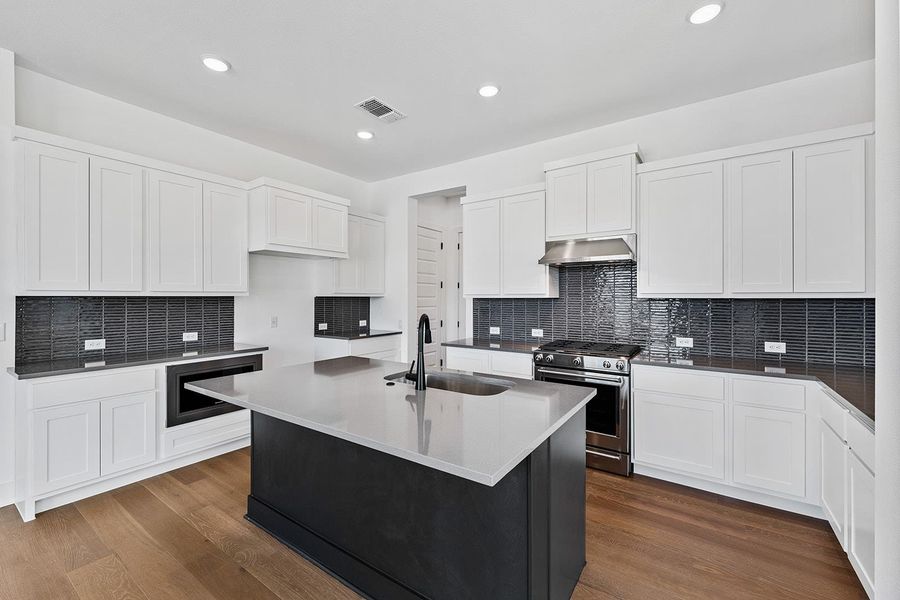 Stainless appliances, tall cabinetry with a large amount of counter space Stainless appliances, tall cabinetry with a large amount of counter space