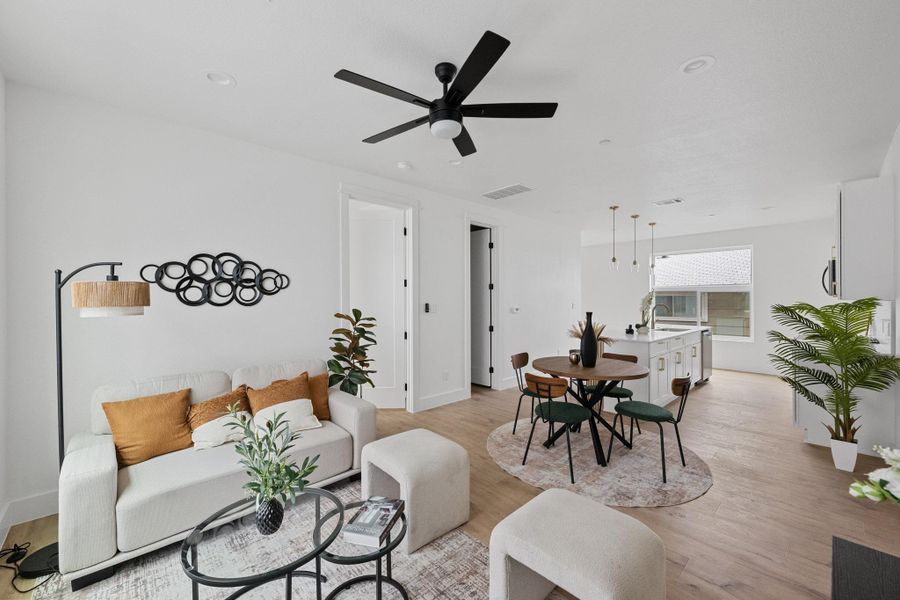 Open-concept living space featuring wood-finish flooring throughout