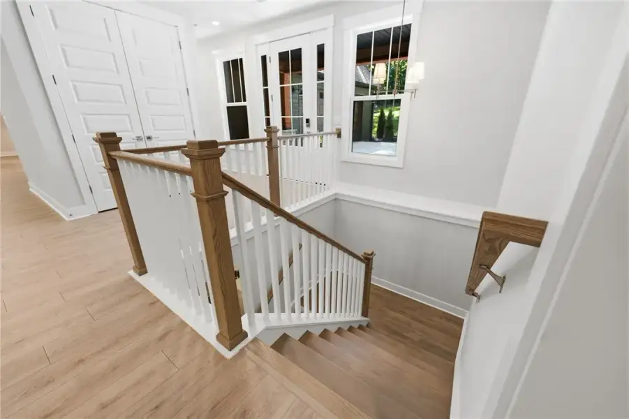 Gleaming hardwood floors and a classic wooden stai