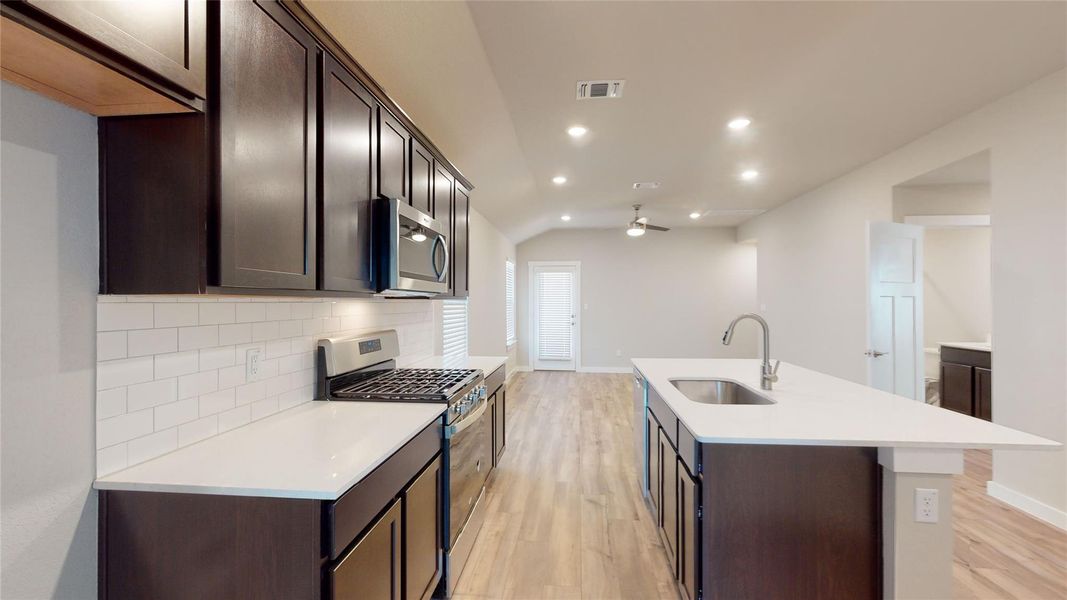 Culinary delights await in this bright kitchen with an inviting island and modern appliances. Culinary delights await in this bright kitchen with an inviting island and modern appliances.