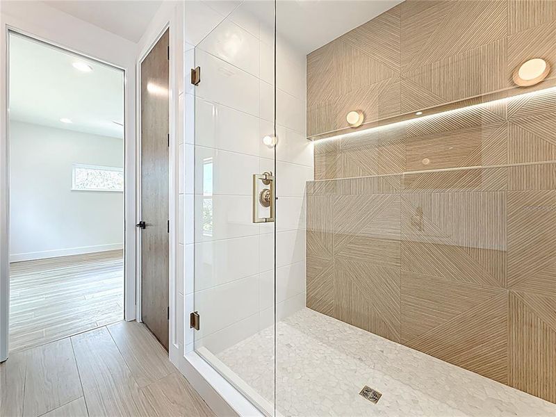 Spa-like en-suite bath featuring dual sinks, an oversized walk-in shower, and a private water closet. Spa-like en-suite bath featuring dual sinks, an oversized walk-in shower, and a private water closet.